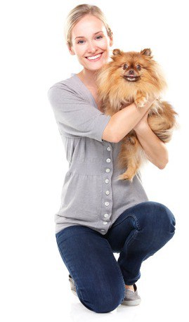 proudly holding her pomeranian puppy